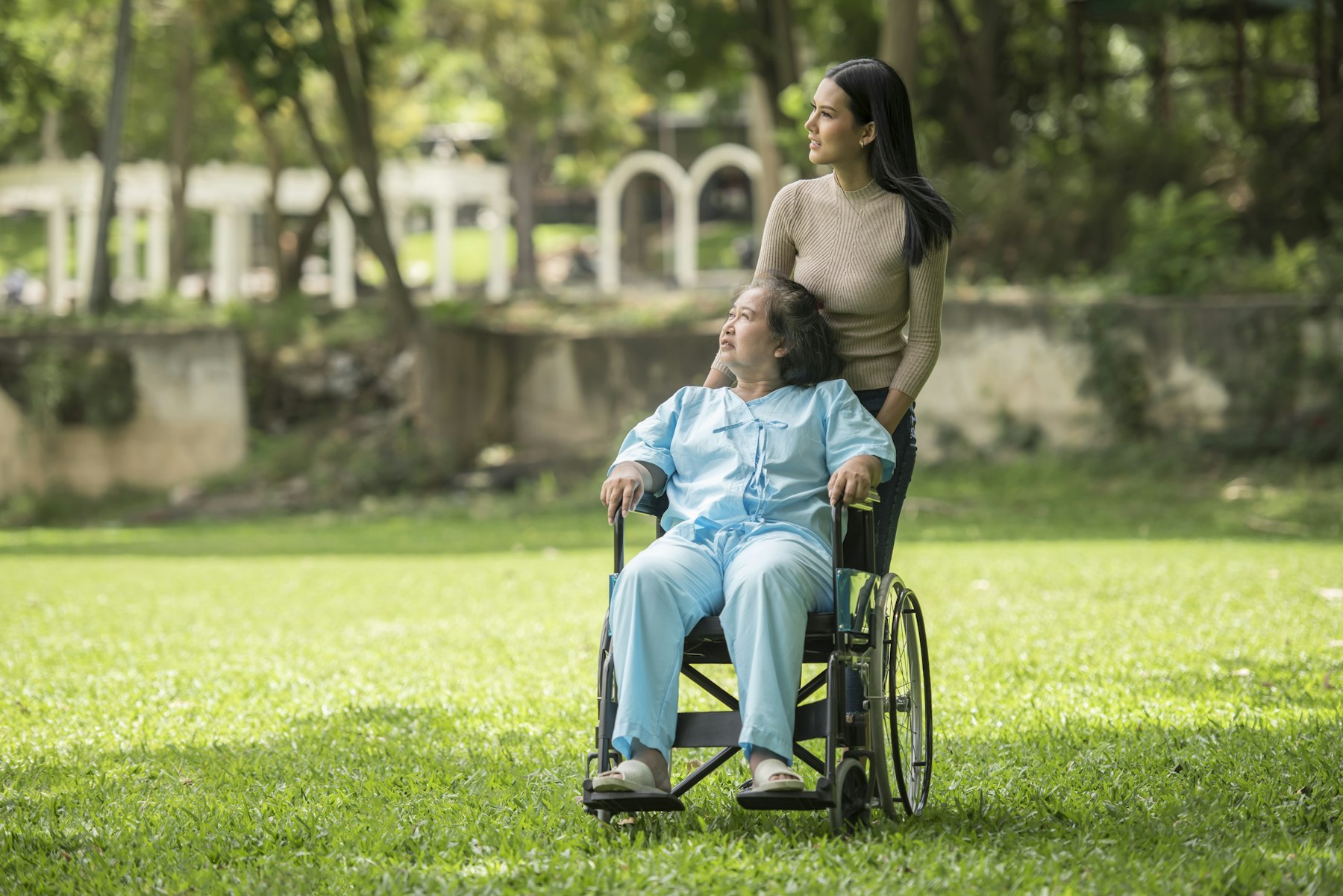 Caregiver with a senior in a wheelchair